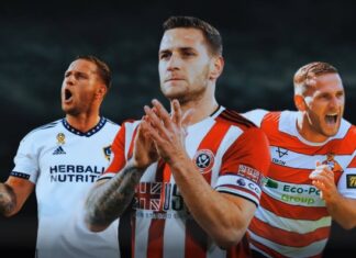 Sheffield United legend Billy Sharp sets up with a container full of football memorabilia